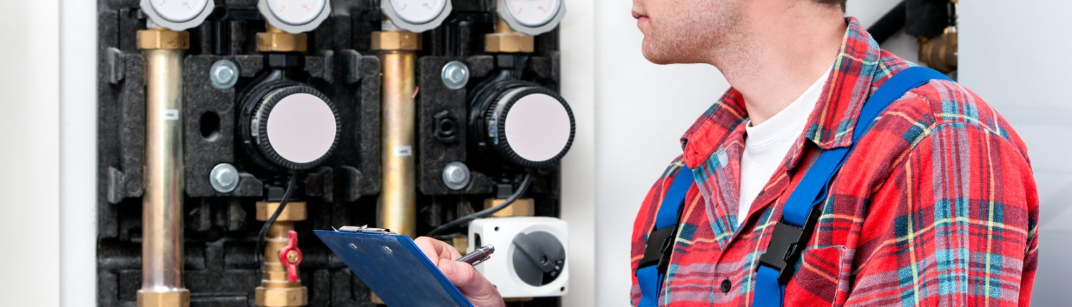 Technician servicing heating boiler